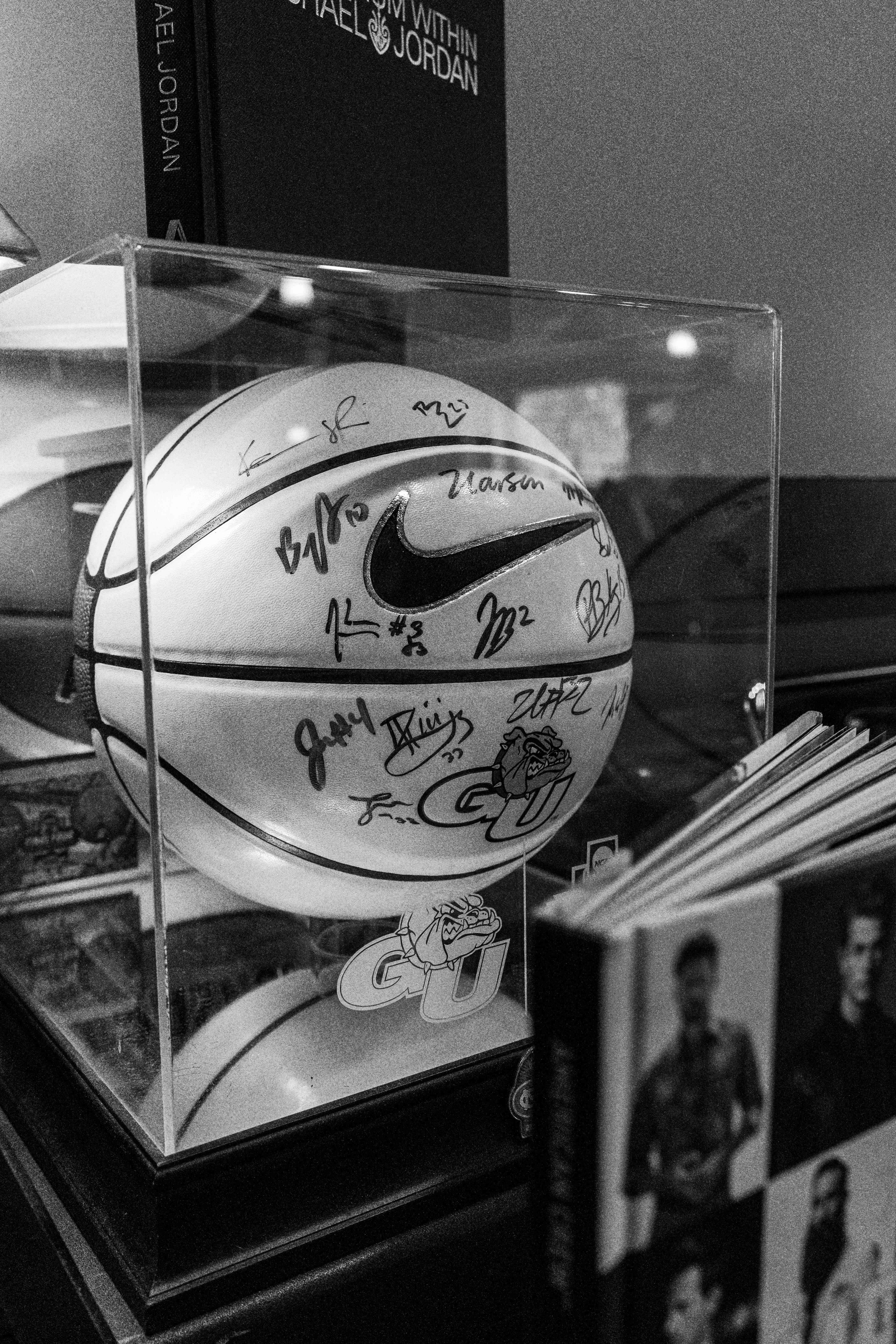 Signed basketball in display case with Gonzaga University branding