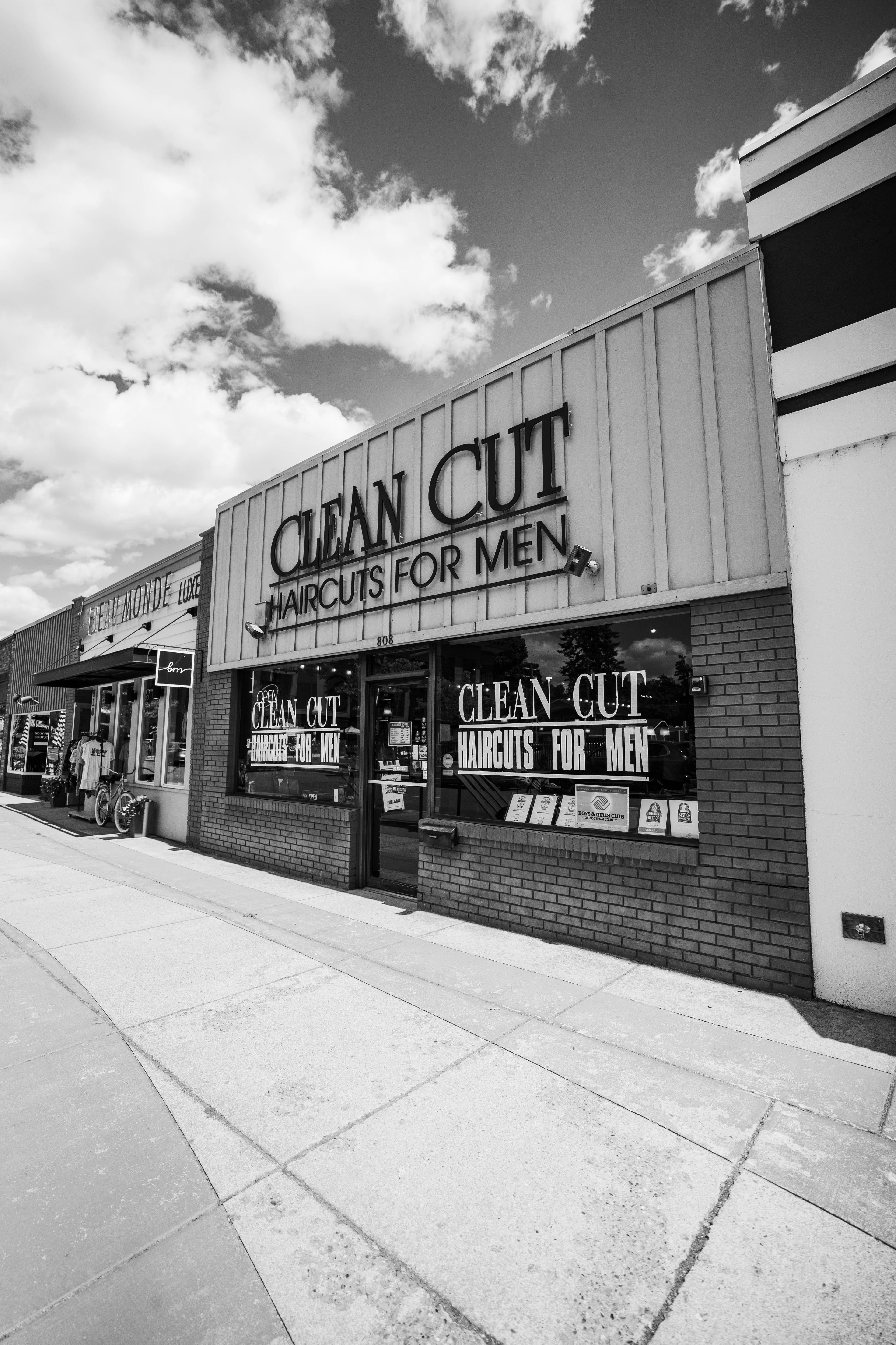 Clean Cut CDA storefront with brick exterior and large windows